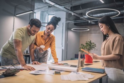 interracial guy and two girls working on project e1661424922900