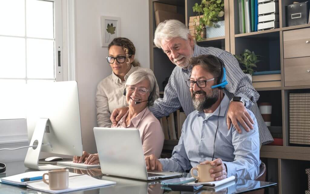 teamwork of business women and men working together with computer and laptop