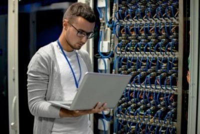 young engineer managing supercomputer servers e1661517039518